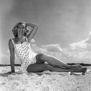 Young Woman Wearing Swimsuit Sitting on Beach Poster Print - 18 x 24 in.