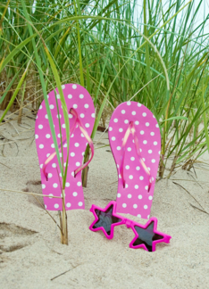 Pink polka dot flip-flops with star sunglasses in sand Greeting Card