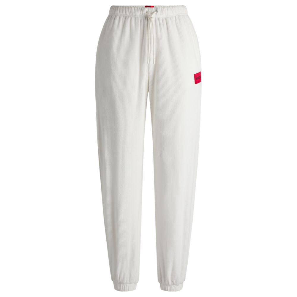 Tracksuit bottoms with red logo label